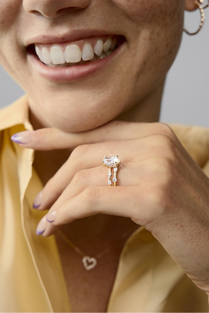 A woman wearing a diamond engagement ring from the Modern Muse Collection.