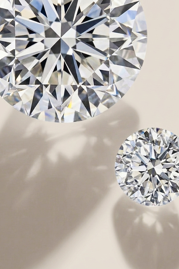 Two different sized diamonds showing their difference in weight.
