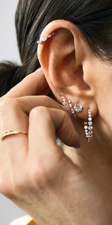 Various diamond earrings stacked
