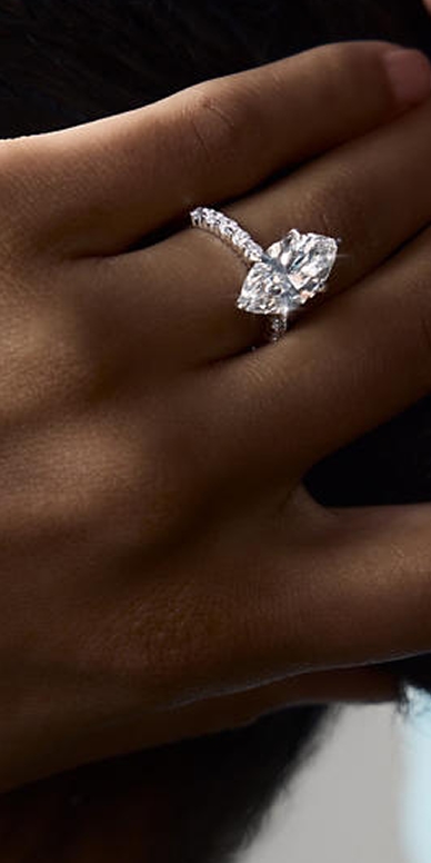 A model showing off a marquise-cut diamond ring from the Iconic Classics Collection.