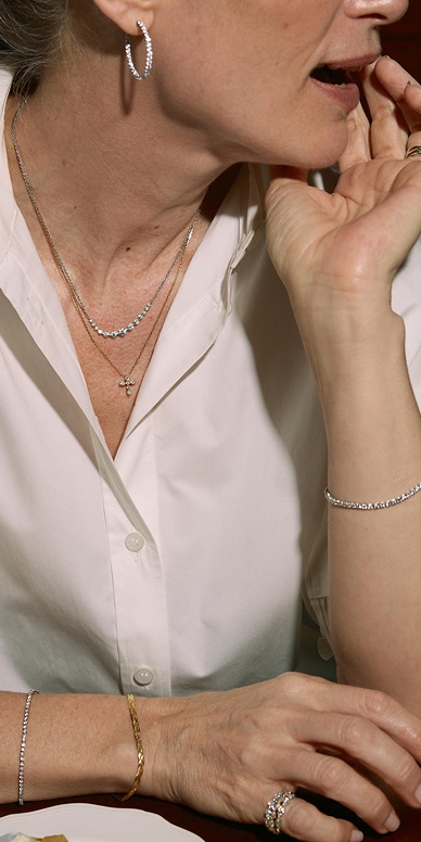 1/4 CT. T.W. Lab-Grown Diamond Cross Necklace in 10K Gold and a 1 CT. T.W. Lab-Grown Diamond Graduated Curved Necklace in Sterling Silver from the Zales Essentials Collection.