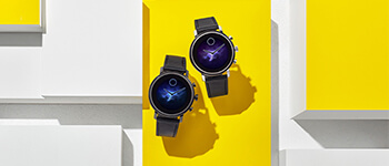 A pair of black watches set against a yellow background