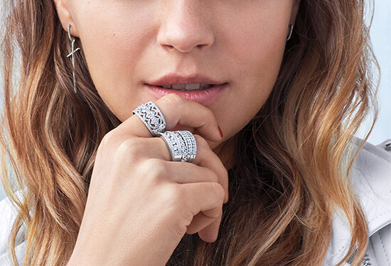 A young woman with three different diamond rings on her right hand