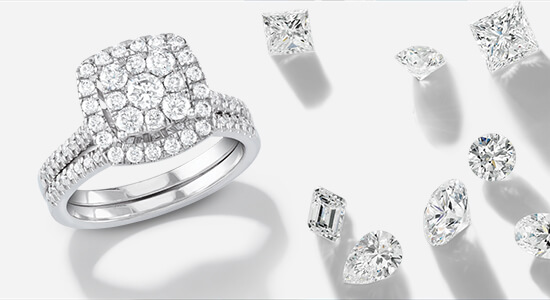 A platinum engagement ring with numerous round diamonds surrounded by raw diamonds of different cuts