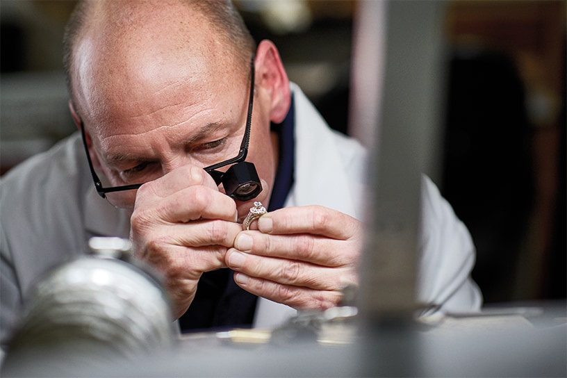 A jeweler repairing some jewelry